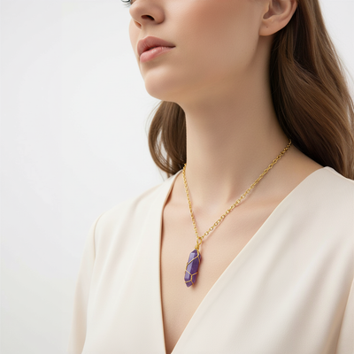 Woman wearing the goldlen Midnight crystal pendant on a white background
